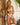 Woman wearing a colorful bikini set standing against a stone wall.