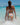 Person in high quality colorful swimsuit walking into clear blue water with a blue sky background
