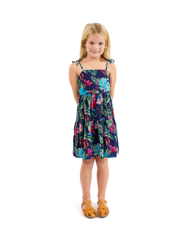 Young girl wearing a floral dress on a white background