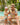 Man and child in matching colorful swim suits by a pool